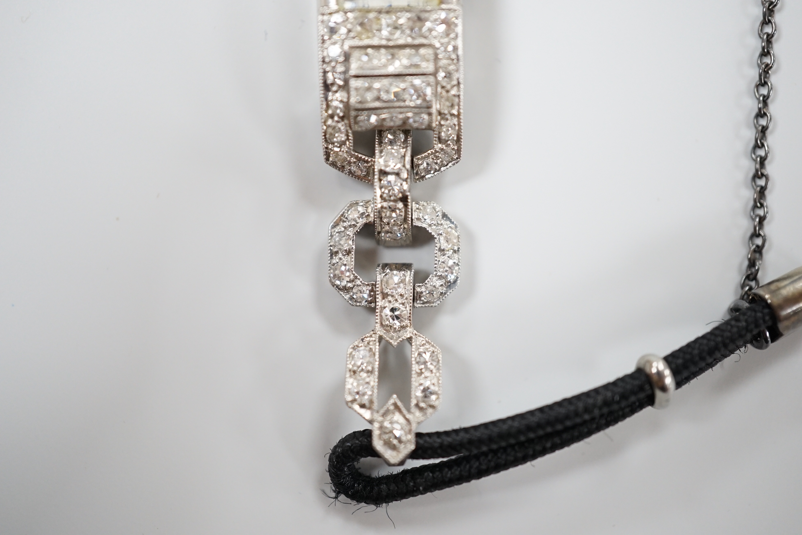 A lady's 1930's/2940's white metal (engraved All Platine) and diamond set manual wind cocktail watch, on a twin fabric strap.